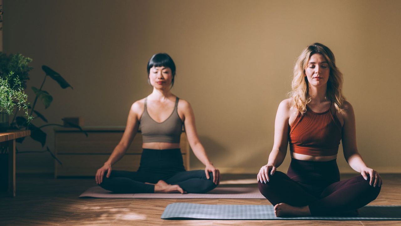 Two woman doing low impact exercises in a yoga studio