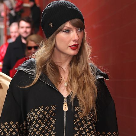 Taylor Swift wears a louis vuitton jacket with a matching beanie at the chiefs game