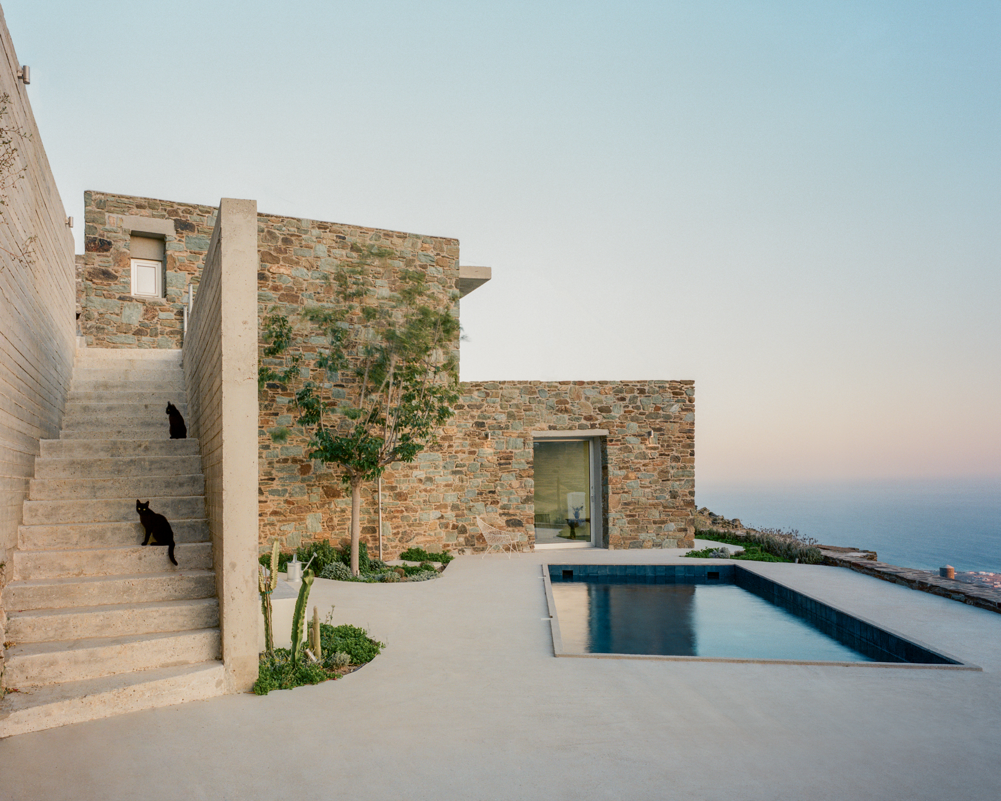 view of a Tinos house, using local vernacular such as stone walls and contemporary design