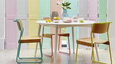 Pastel rainbow shutters in dining room with colorful chairs