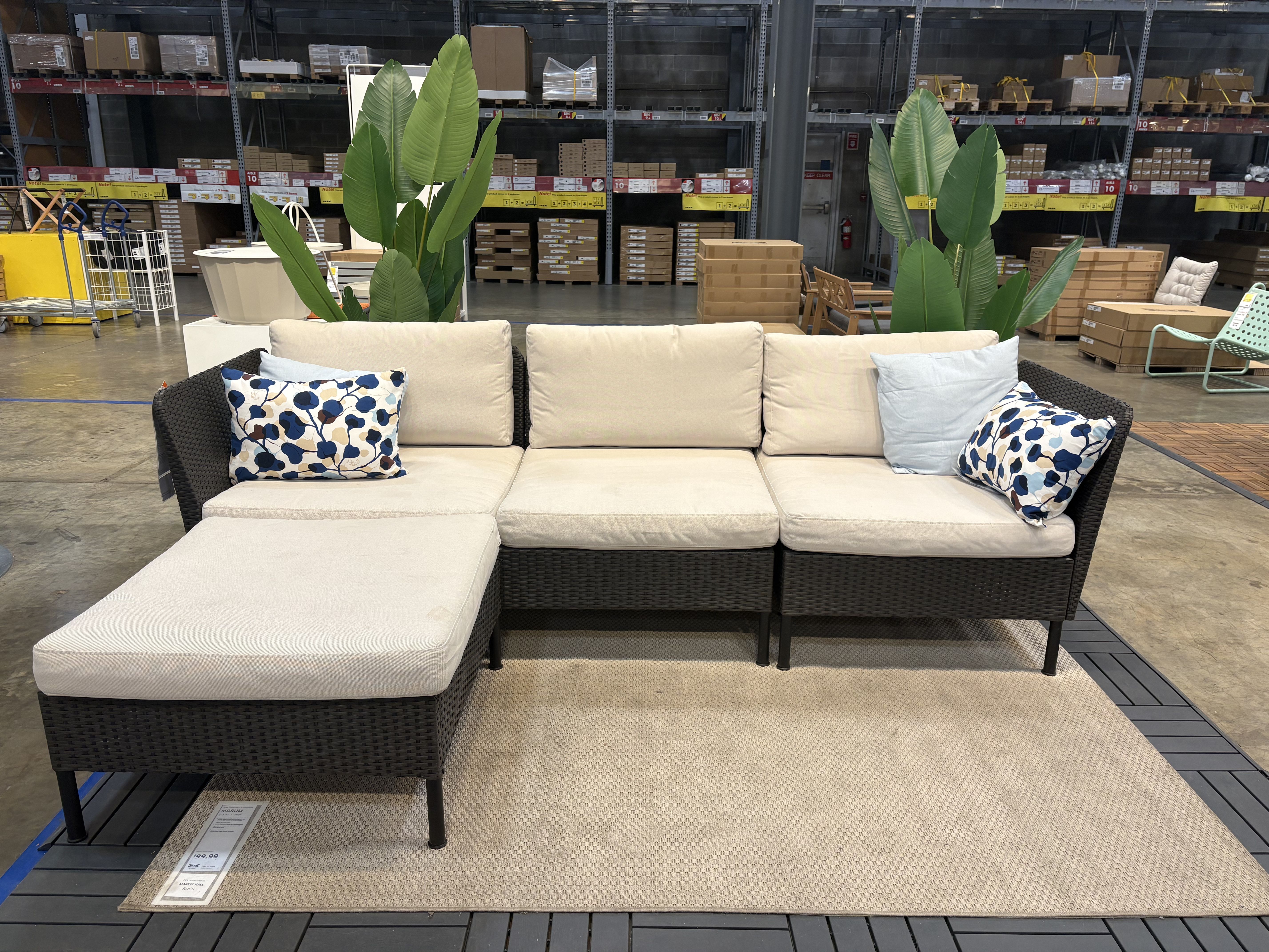 an outdoor sofa set with a black frame sitting in an ikea showroom