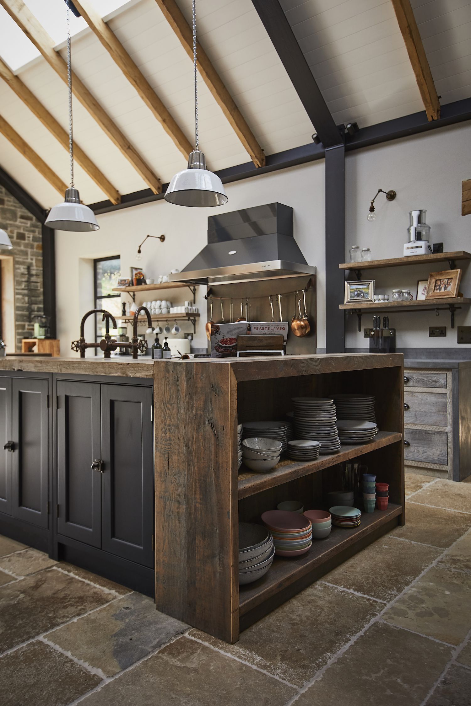 kitchen with industrial island made from wood and painted black doors