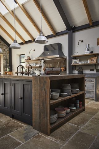 kitchen with industrial island made from wood and painted black doors