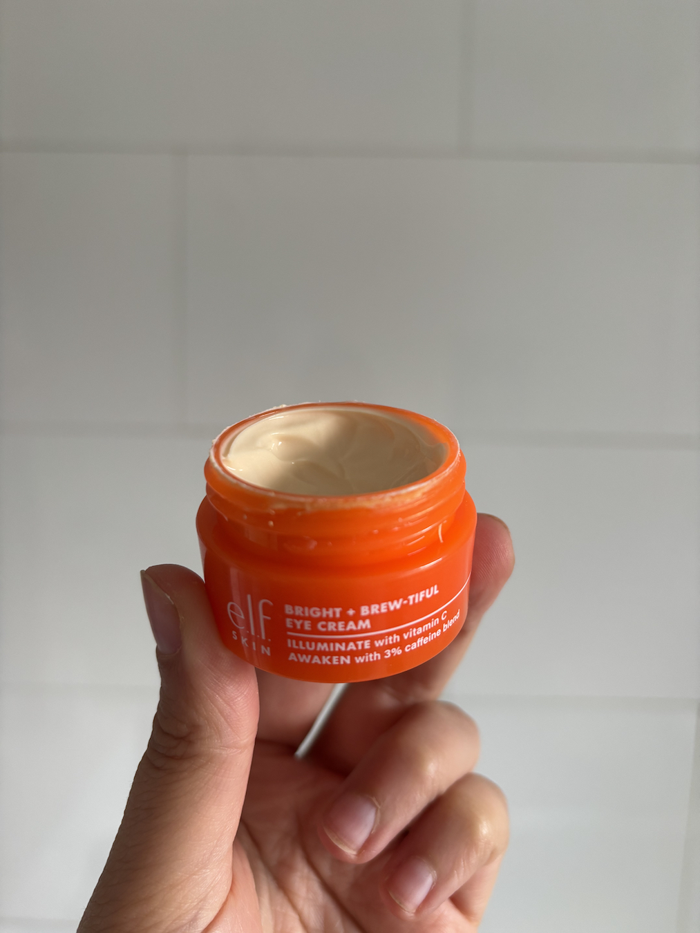 Mica Ricketts holding E.l.f. Skin Bright + Brew-tiful Eye Cream