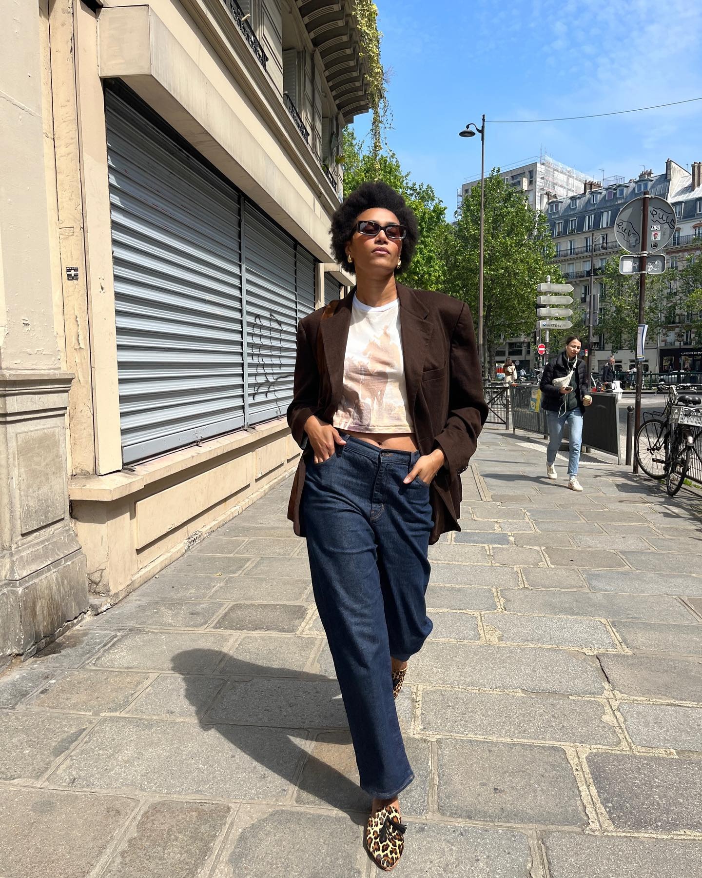 Influencer @lenafarl wears leopard print loafers with jeans, a tee and a dark brown blazer.