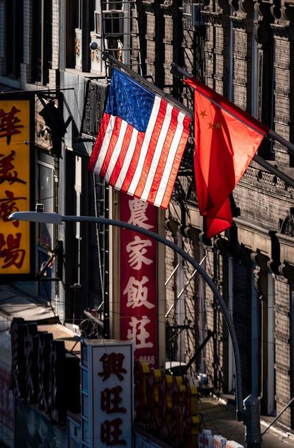topshot a us and chinese flag are seen in chinatown on october 14, 2019 in new york city photo by johannes eisele afp photo by johannes eiseleafp via getty images