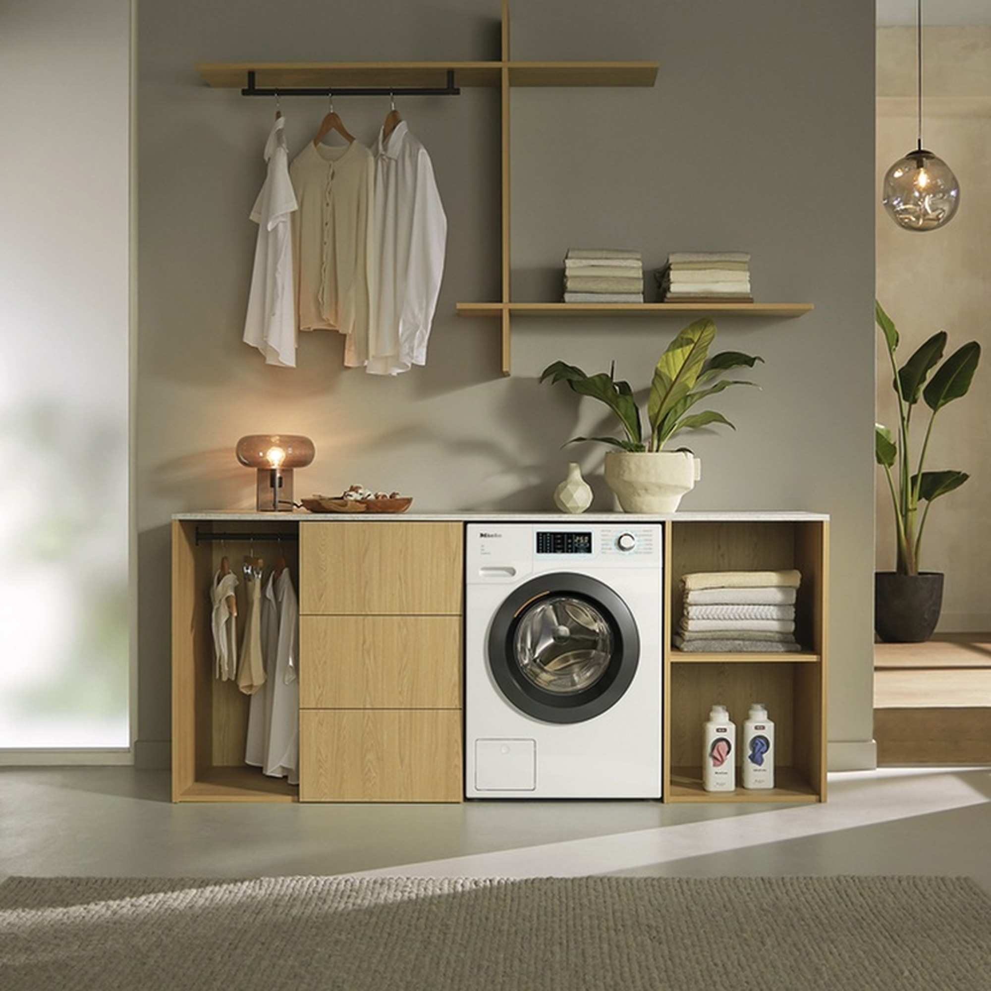 a Scandi-style open plan utility area with wooden cabinets and a Miele washing machine
