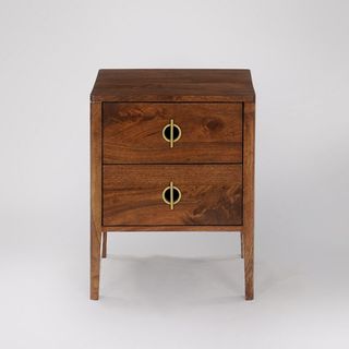 A mango wood bedside table with gold handles