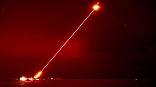 The DragonFire laser shooting at an aerial target.