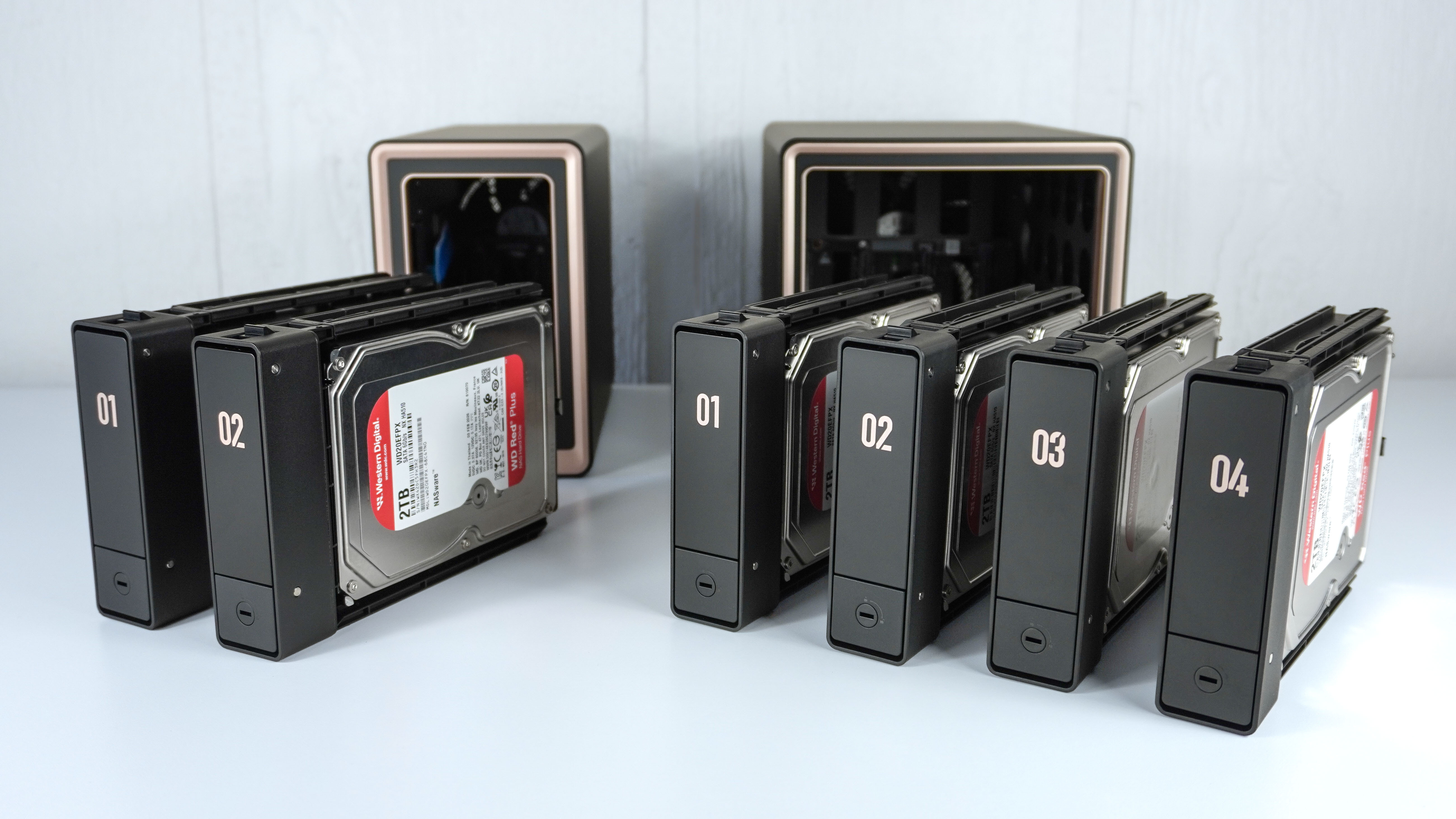 The Ugreen DXP2800 GT and DXP4800 GT side by side with their drive bay enclosures filled with hard drives