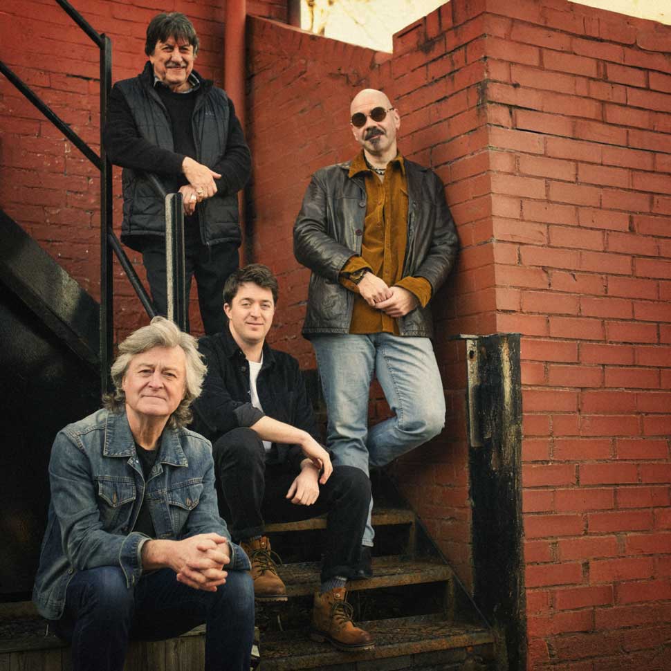 Ten Years After standing on some stairs