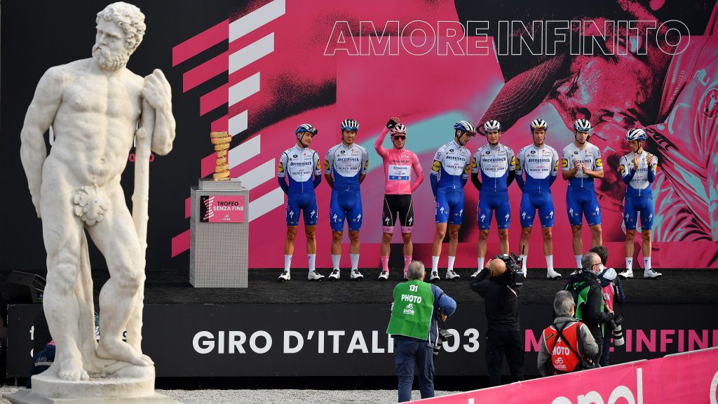 SAN DANIELE DEL FRIULI ITALY OCTOBER 20 Start Joao Almeida of Portugal Pink Leader Jersey Davide Ballerini of Italy lvaro Jose Hodeg Chagui of Colombia Mikkel Honore of Denmark Iljo Keisse of Belgium James Knox of The United Kingdom Fausto Masnada of Italy Pieter Serry of Belgium and Team Deceuninck QuickStep Trofeo Senza Fine Trophy Piazza della Liberta Udine City Public Fans Landscape Team Presentation during the 103rd Giro dItalia 2020 Stage 16 a 229km stage from Udine to San Daniele Del Friuli 249m girodiitalia Giro on October 20 2020 in San Daniele Del Friuli Italy Photo by Stuart FranklinGetty Images