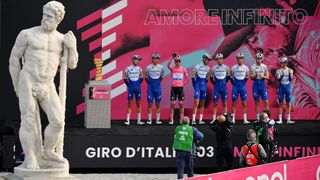 SAN DANIELE DEL FRIULI ITALY OCTOBER 20 Start Joao Almeida of Portugal Pink Leader Jersey Davide Ballerini of Italy lvaro Jose Hodeg Chagui of Colombia Mikkel Honore of Denmark Iljo Keisse of Belgium James Knox of The United Kingdom Fausto Masnada of Italy Pieter Serry of Belgium and Team Deceuninck QuickStep Trofeo Senza Fine Trophy Piazza della Liberta Udine City Public Fans Landscape Team Presentation during the 103rd Giro dItalia 2020 Stage 16 a 229km stage from Udine to San Daniele Del Friuli 249m girodiitalia Giro on October 20 2020 in San Daniele Del Friuli Italy Photo by Stuart FranklinGetty Images