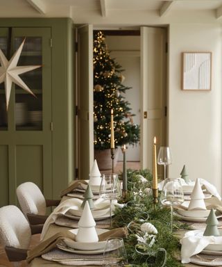 dining room with neutral color scheme, foliage garland and long taper candles