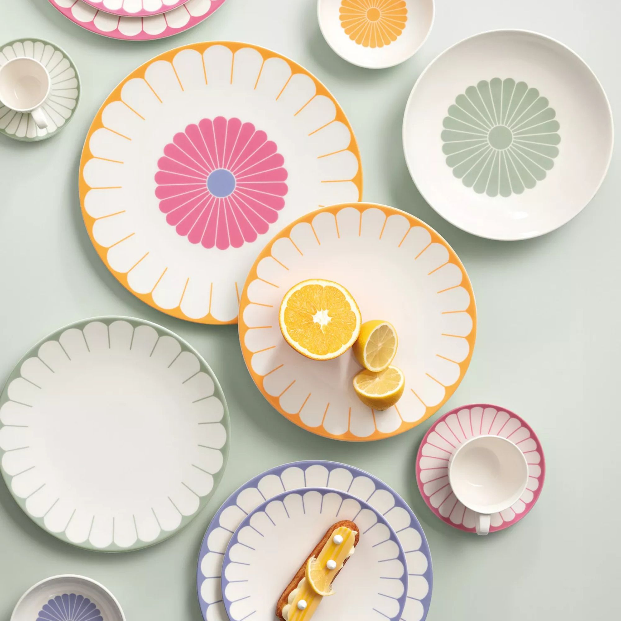 Villeroy &amp;amp; Boch Fleur Collection at Macy's, showing a set of mix and match white porcelain plates with varying pastel petal edge painted designs in sage, orange, pink, and lilac