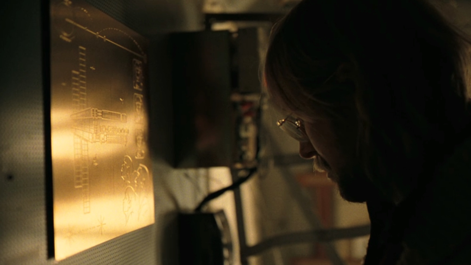 Grace looking at one of the placards in Project Hail Mary