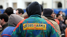Man wearing a hoodie and Jesus Army jacket