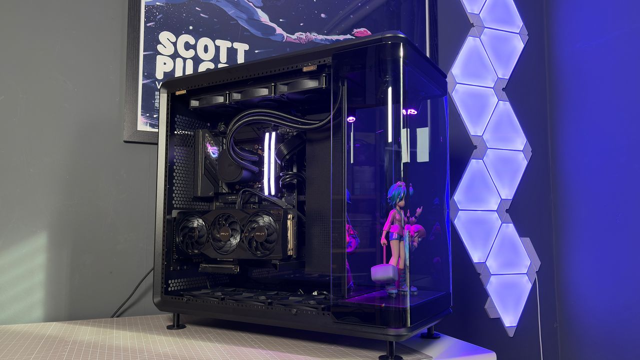 The CoolerMaster MasterFrame 360 Panoramic PC case with various components installed on a desk.