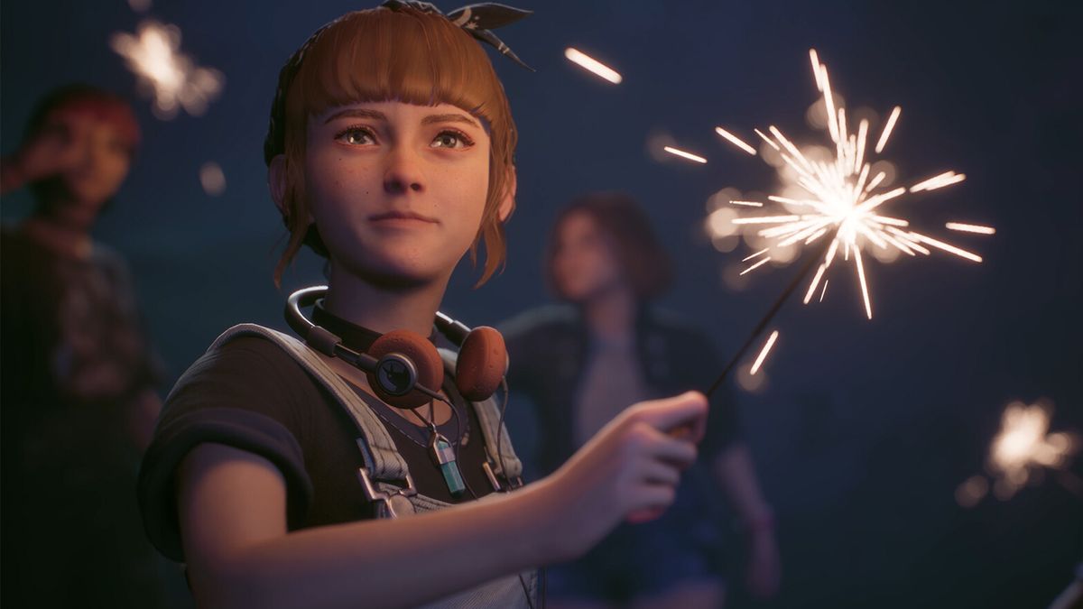 A teenager holding a sparkler