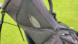 A very worn hip pad on a golf stand bag