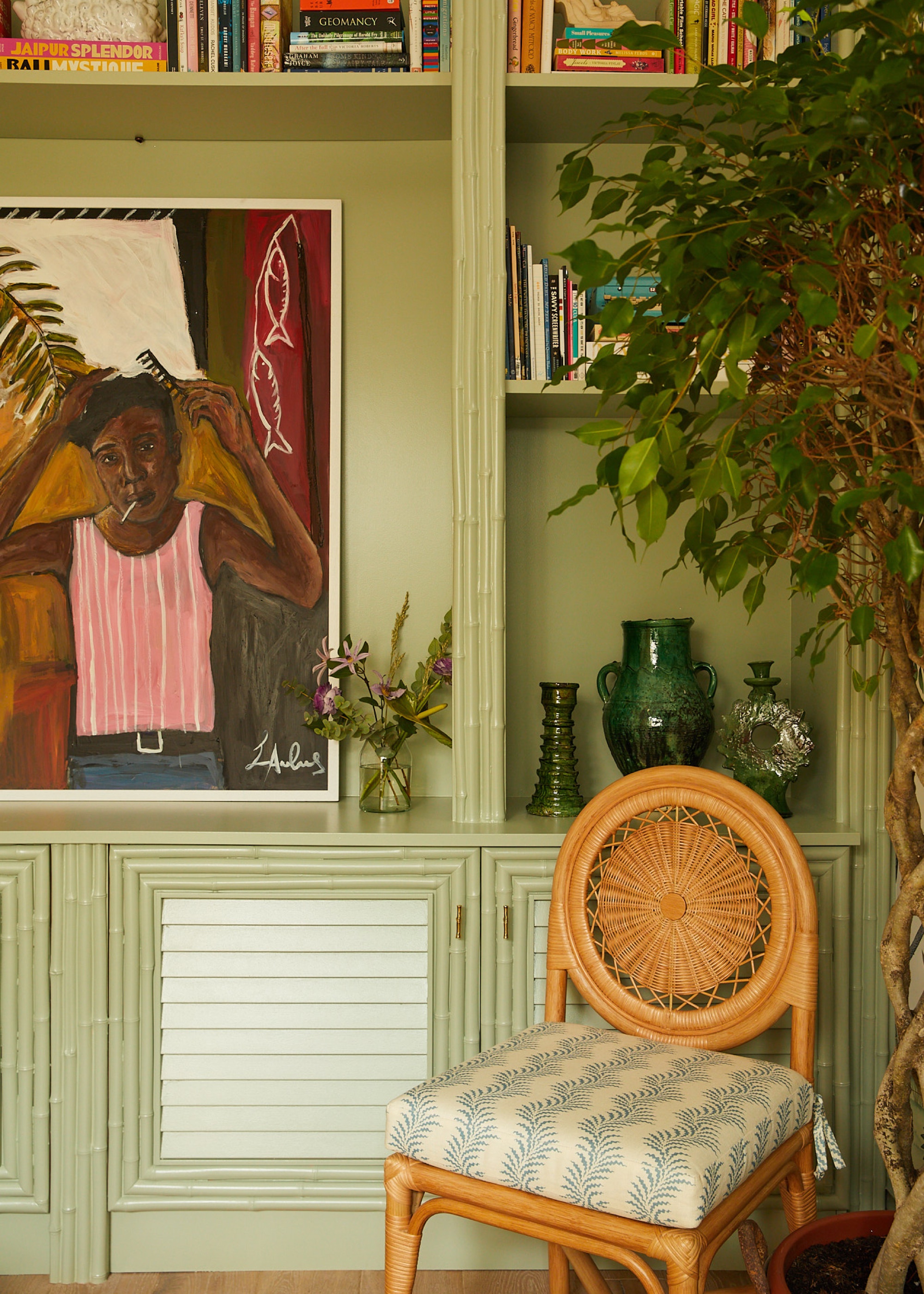 green shelving unit and antique chair in the corner of a living room