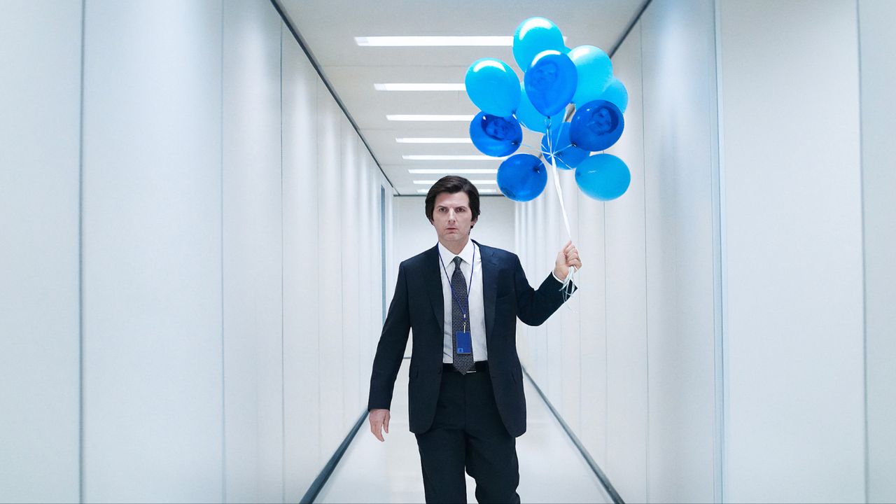 A still of Adam Scott holding blue balloons in &#039;Severance&#039; season 2.