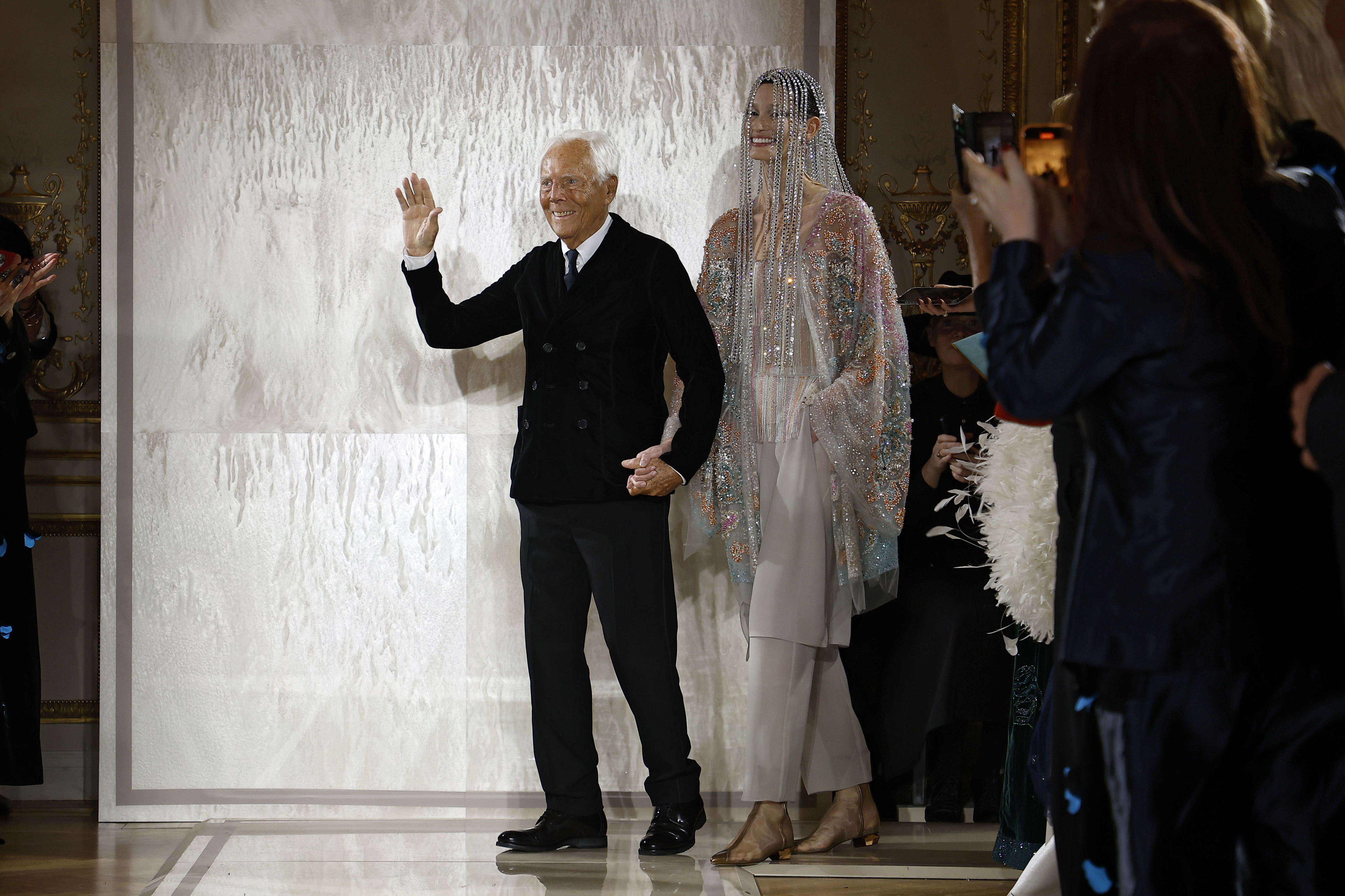Giorgio Armani takes a bow with a model at the Armani Priv&amp;eacute; show in January 2025