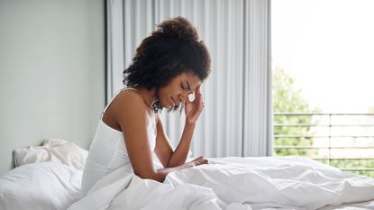 Woman waking up with a headache