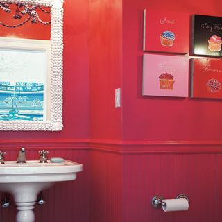 bathroom with red wall and washbasin and mirror