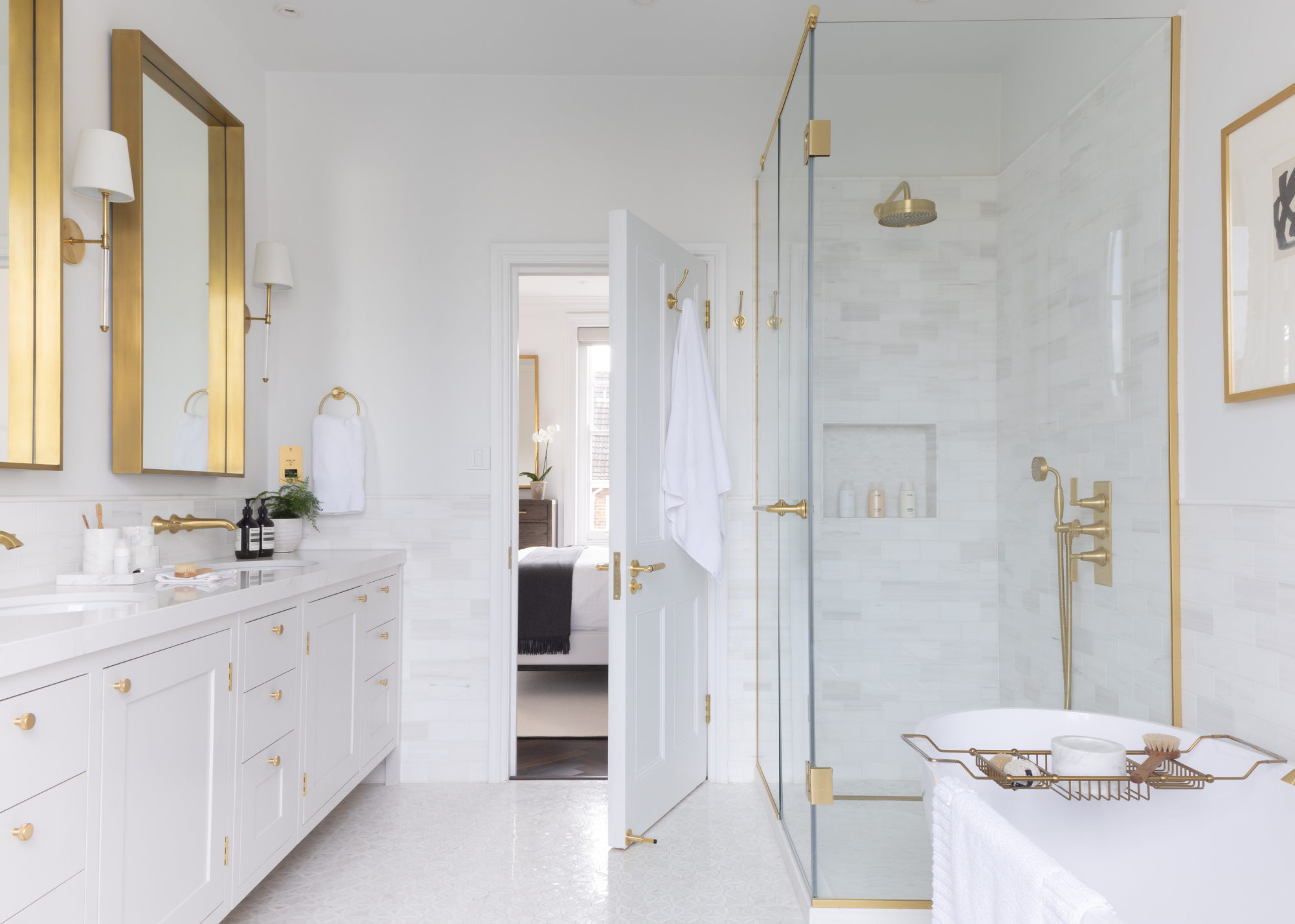 A modern traditional white bathroom with all brushed brass fixtures and fittings