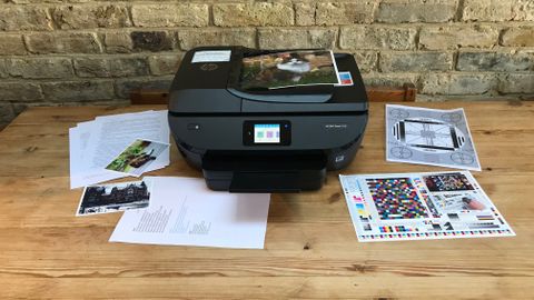 Printer on table with test pages