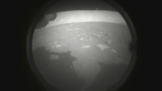 This is the first photo NASA's Perseverance rover beamed back to Earth after it landed on Mars on Feb. 18, 2021.