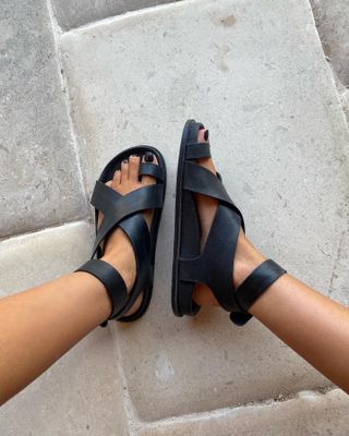 Black sandals with black pedicure