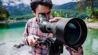 Man looking through Nikon Monarch spotting scope