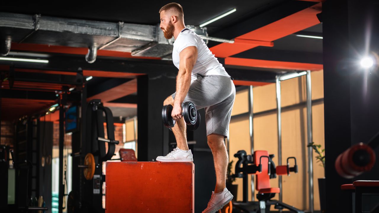 Man performing a dumbbell step-up