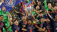 Marquinhos of Paris Saint-Germain lifts the UEFA Champions League trophy after Paris Saint-Germain's first ever title win