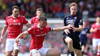 Tommy Conway of Middlesbrough is challenged by Dominic Hyam of Wrexham during the Sky Bet Championship match between Wrexham AFC and Middlesbrough.