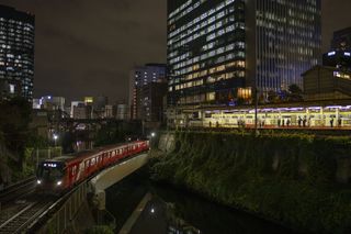 a night image of a train and a building