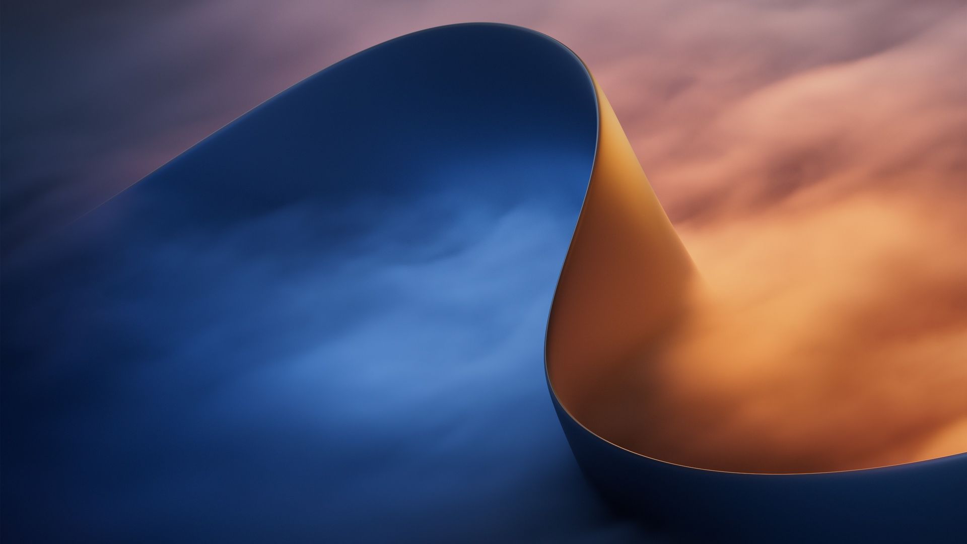 Abstract Microsoft wallpaper featuring a smooth curved blue shape against a blurred orange and purple gradient background.