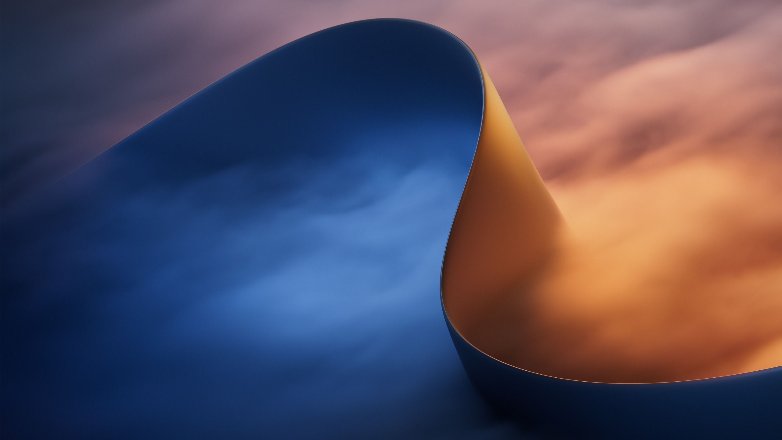Abstract Microsoft wallpaper featuring a smooth curved blue shape against a blurred orange and purple gradient background.