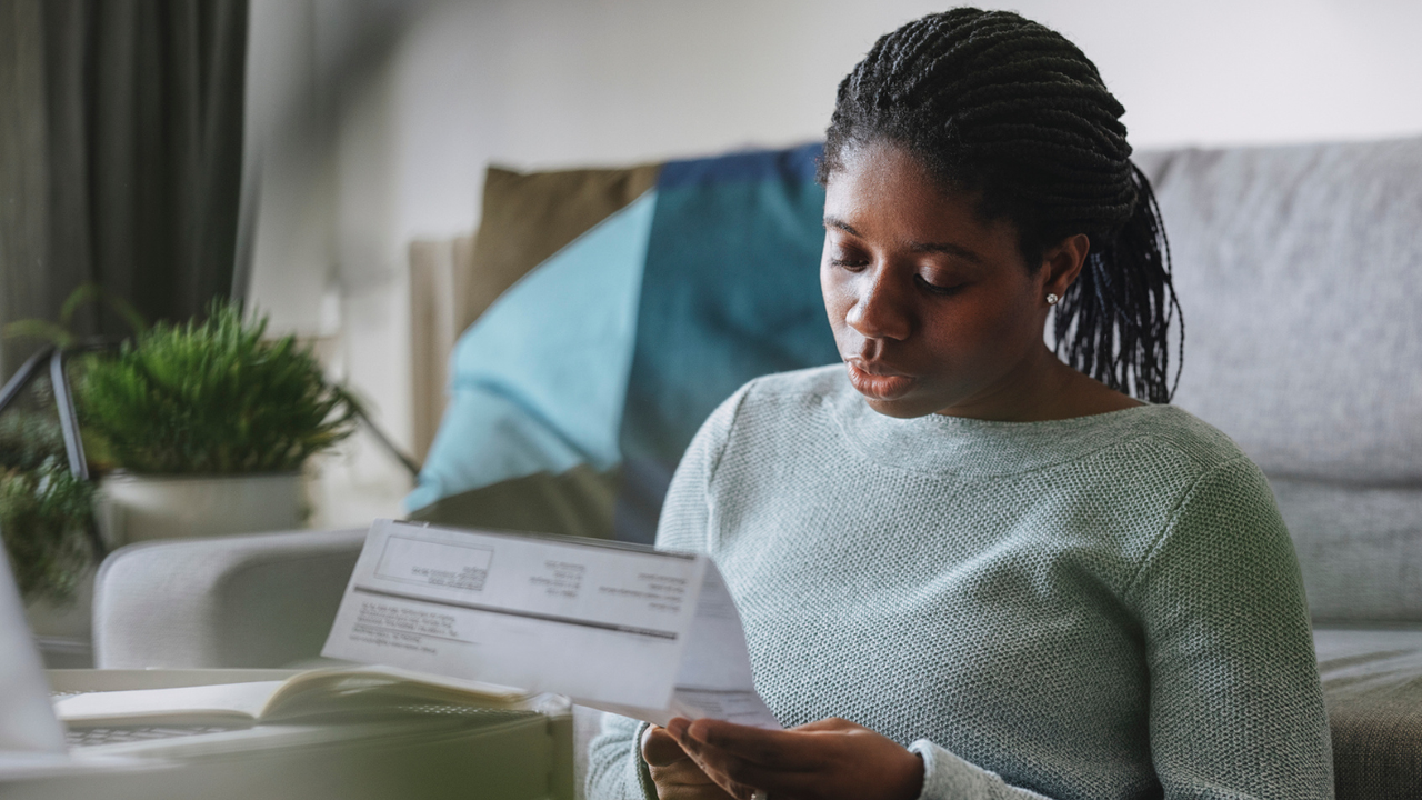 Woman reads utility bill