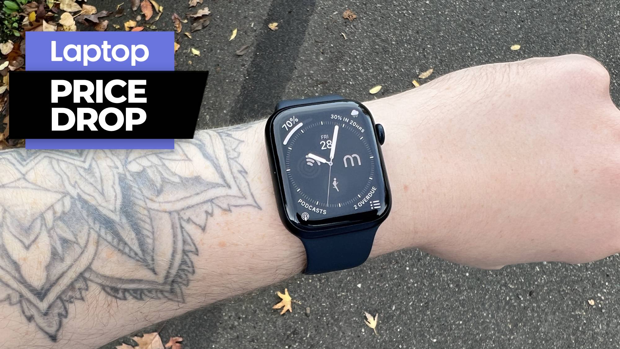 Man with tattoos on arm wearing Apple Watch Series 8 in black