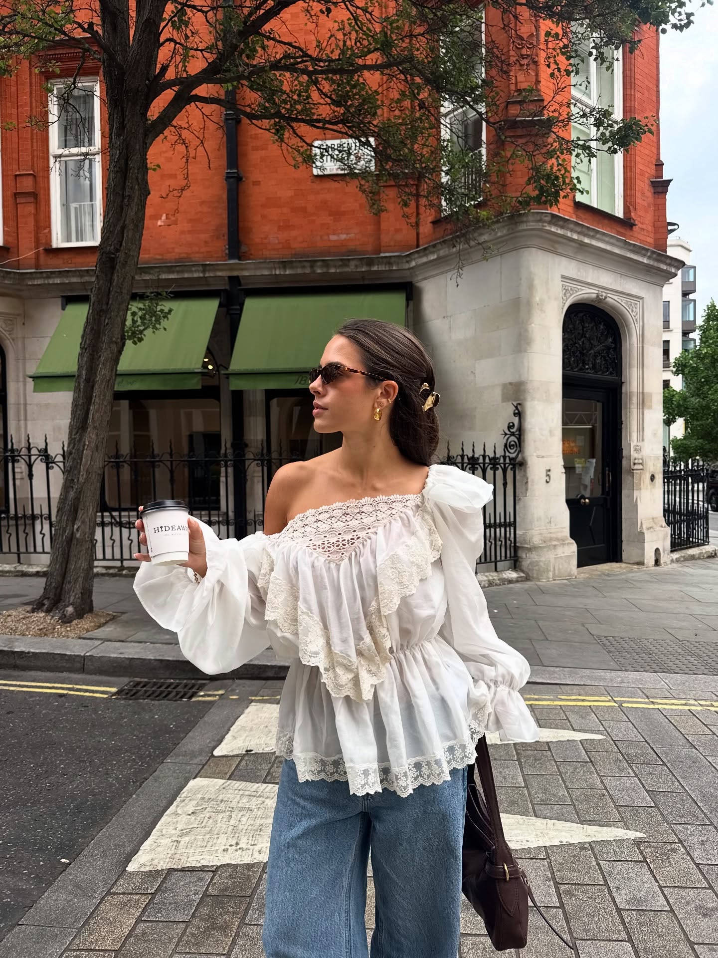 Tia Dewitt wears a ruffle blouse and wide leg jeans