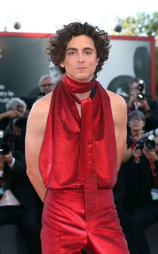 Timothee Chalamet at the 2022 Venice Film Festival premier of Bones and All in an all red set.