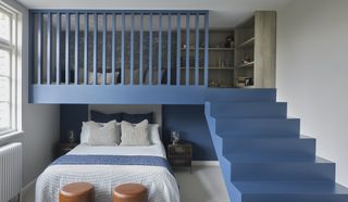 twin bedroom with mezzanine floor painted blue