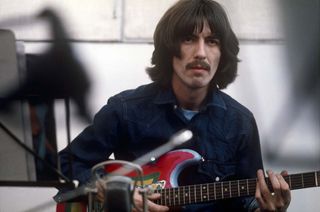 George Harrison with his 1961 Fender Stratocaster, nicknamed Rocky and refinished in Day-Glo paint-job