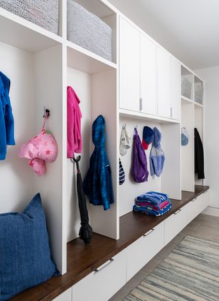 mudroom ideas with coat hanging space and closed door cupboards