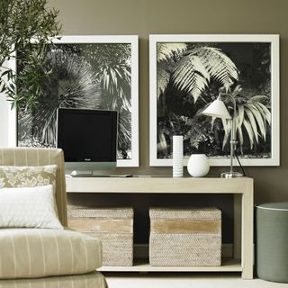room with frames white table lamp and sofa chair