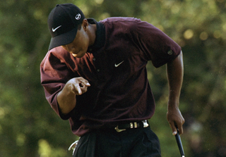 Tiger Woods points at the hole after holing a putt during the 2000 PGA Championship