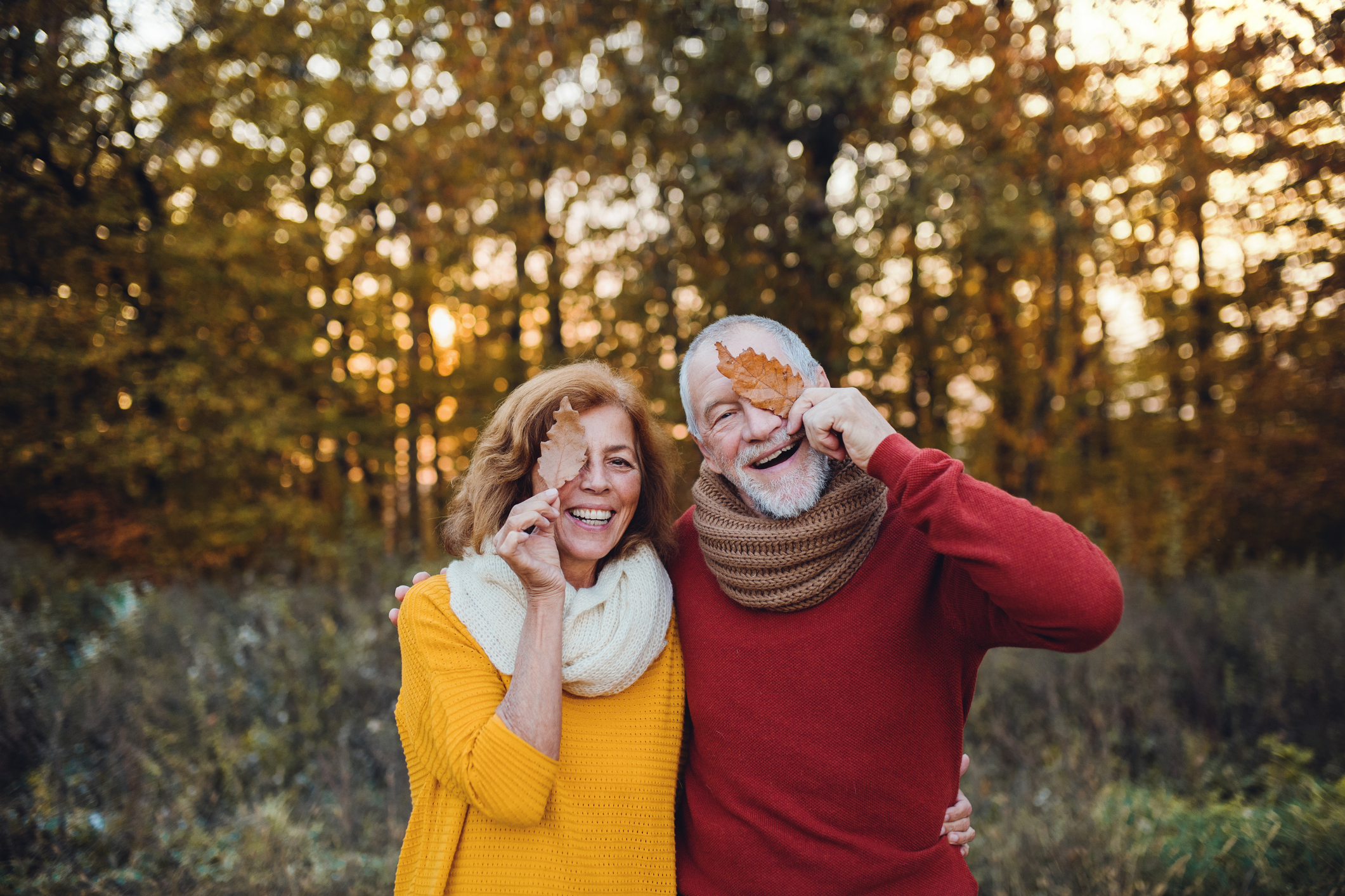 A couple enjoying a walk outside in the fall. 